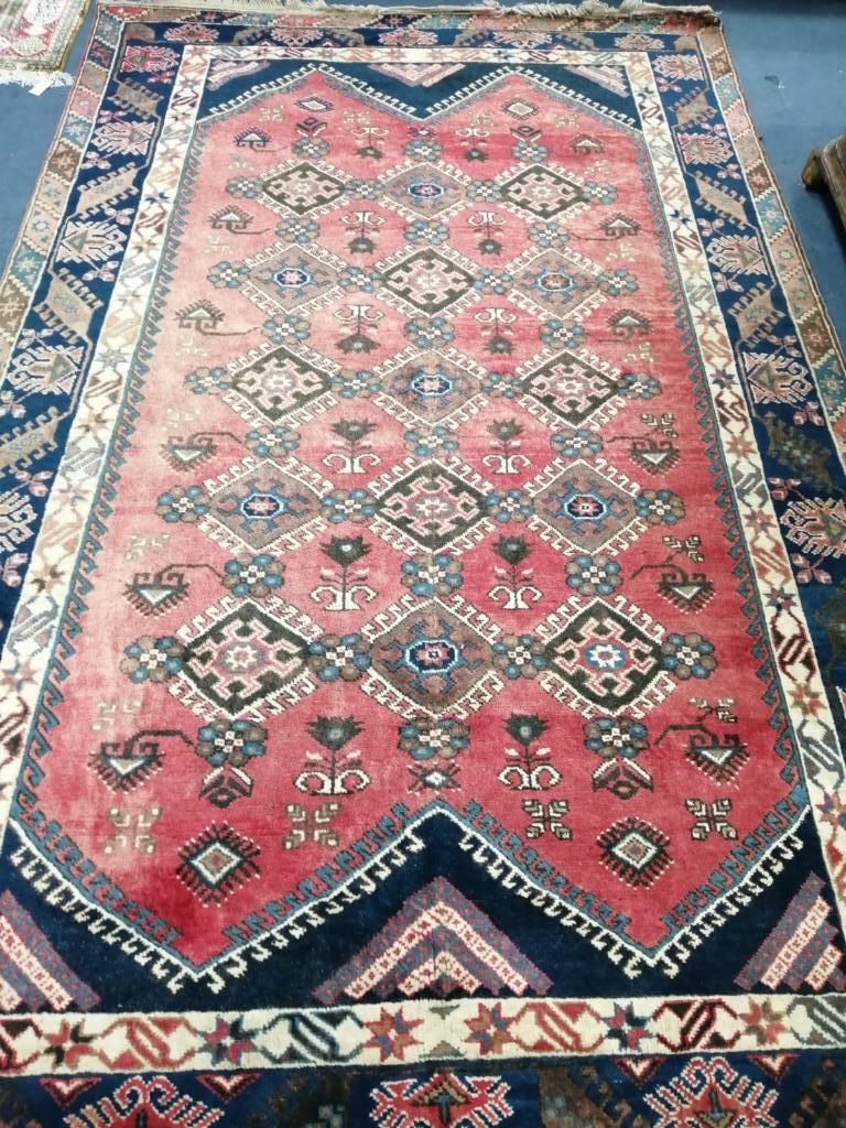 A Cauasian design red ground carpet, 310 x 194cm